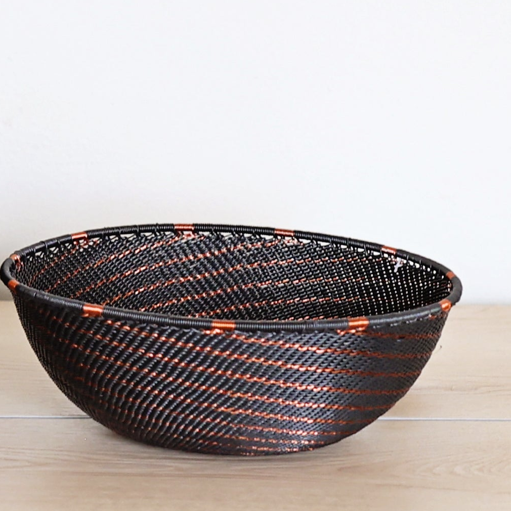 Copper & Black Zulu Bowl handwoven in South Africa with a rich black base and shimmering bare copper wire accents.