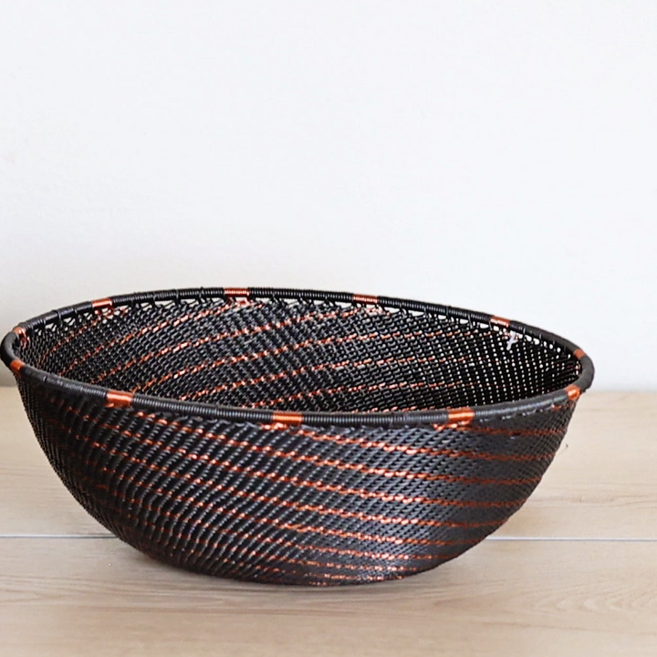 Copper & Black Zulu Bowl handwoven in South Africa with a rich black base and shimmering bare copper wire accents.