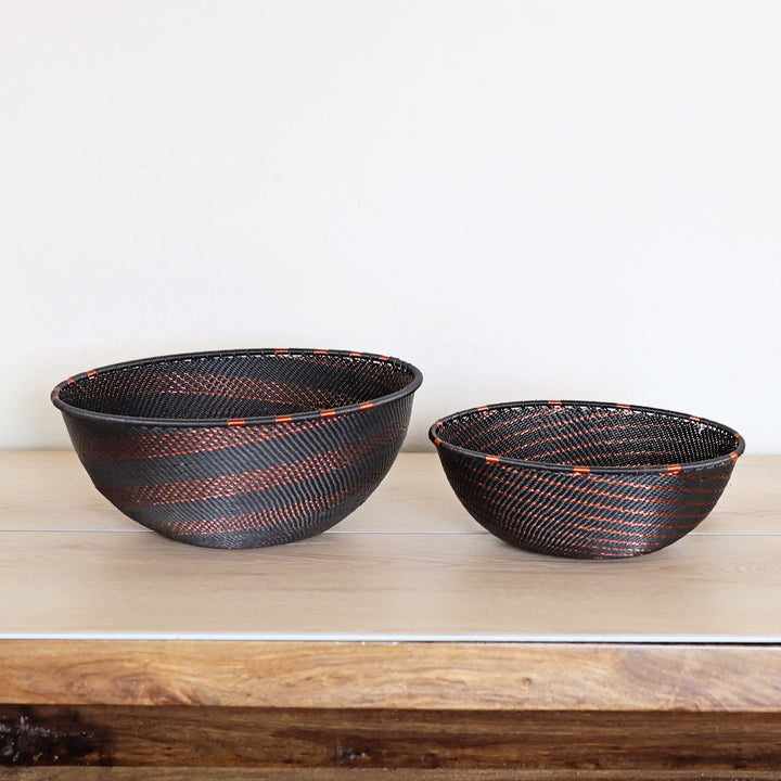 Side view of a Copper & Black Zulu Bowl featuring intricate spiral weaving and copper wire detailing by South African artisans.