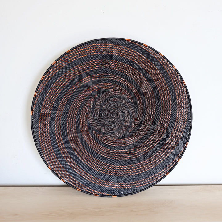 Copper & Black Zulu Extra Large Shallow Basket handwoven in South Africa with a rich black base and shimmering bare copper wire accents.
