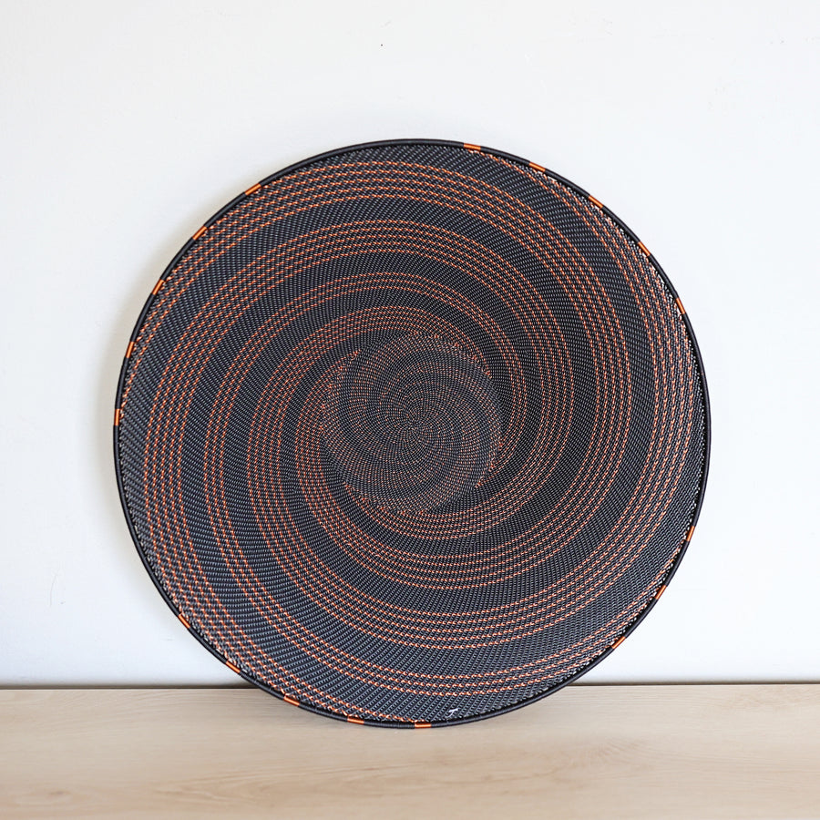 Copper & Black Zulu Extra Large Shallow Basket handwoven in South Africa with a rich black base and shimmering bare copper wire accents.