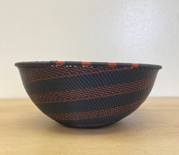 Handwoven Copper and Black Zulu extra large bowl wire basket featuring fine concentric spiral detailing.