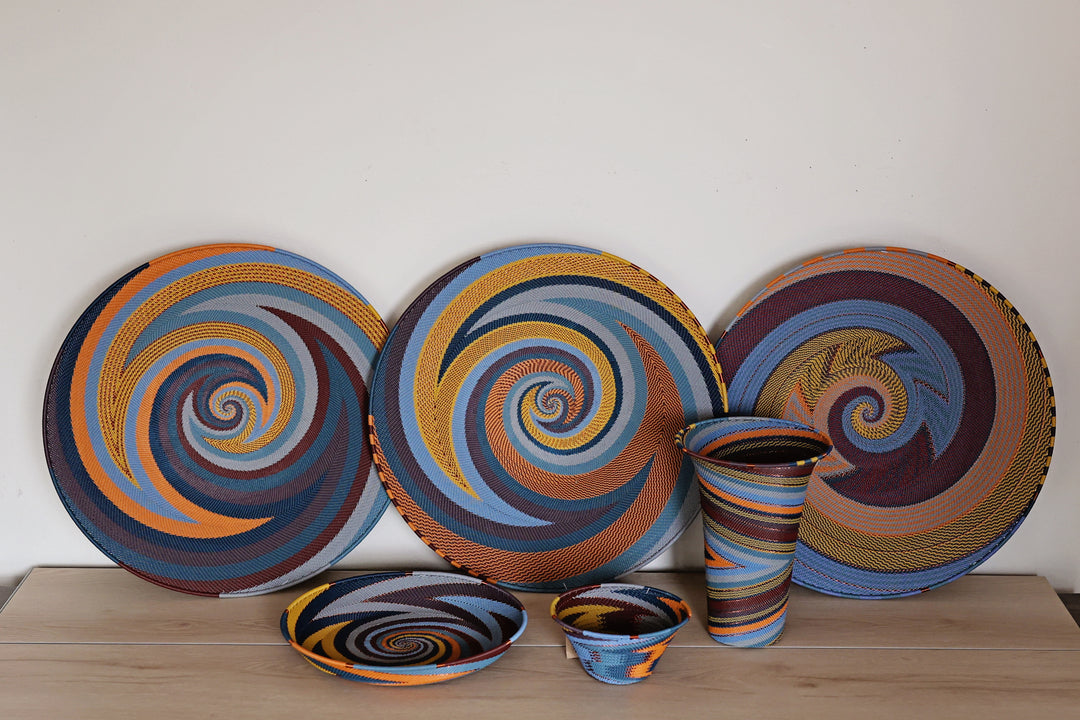Assorted Cove Zulu Wire Baskets handwoven in South Africa in layered coastal and earthy tones with intricate artisan patterns.