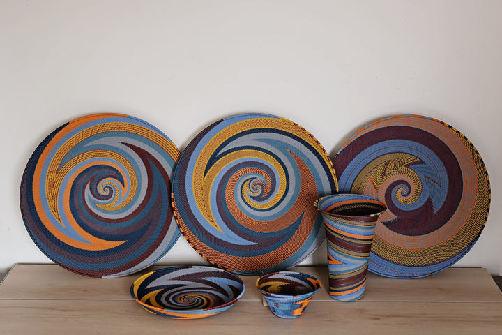 Assorted Cove Zulu Wire Baskets handwoven in South Africa in layered coastal and earthy tones with intricate artisan patterns.