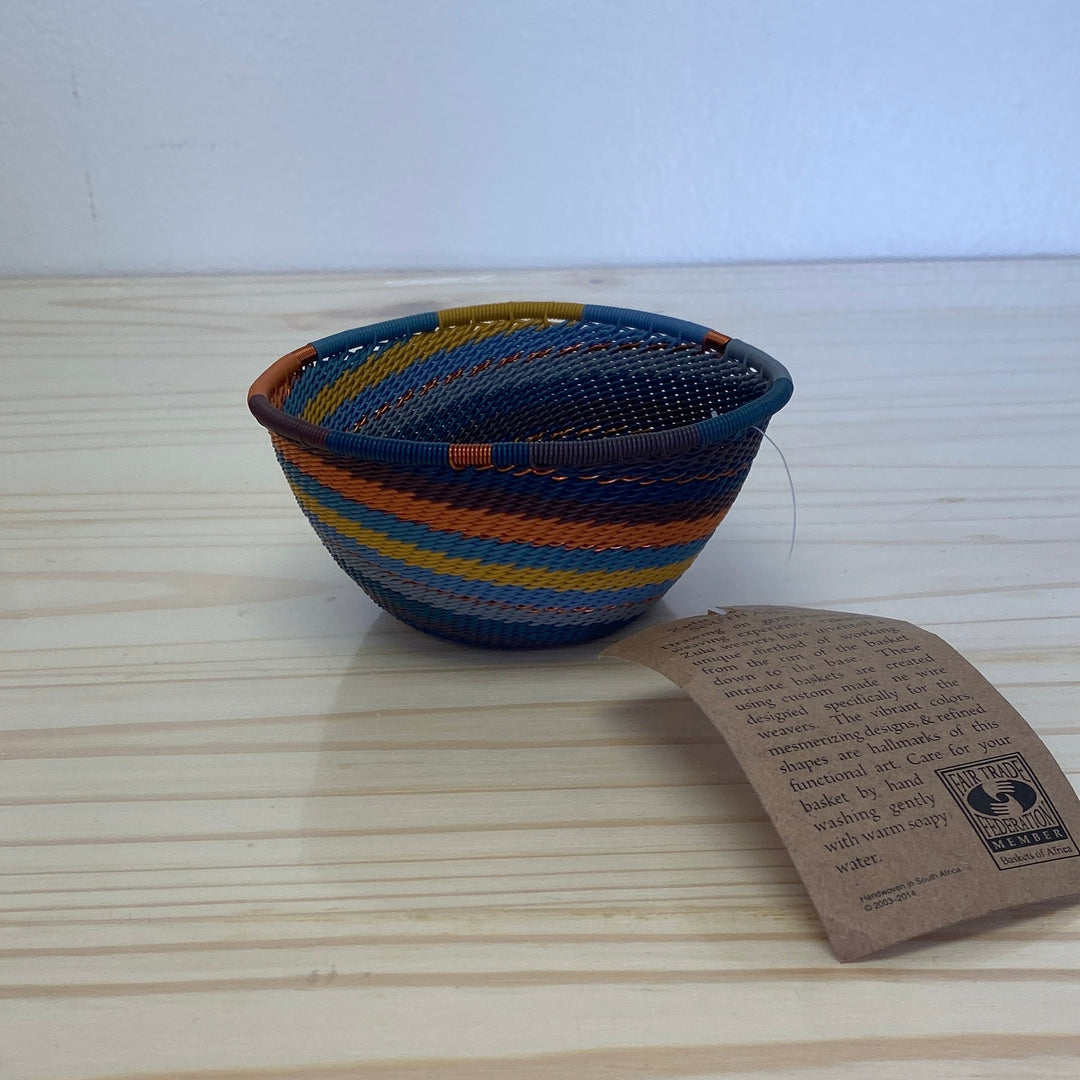 Cove Zulu Wire Triangle Bowl handwoven in South Africa with intricate woven patterns in layered coastal and earthy tones.
