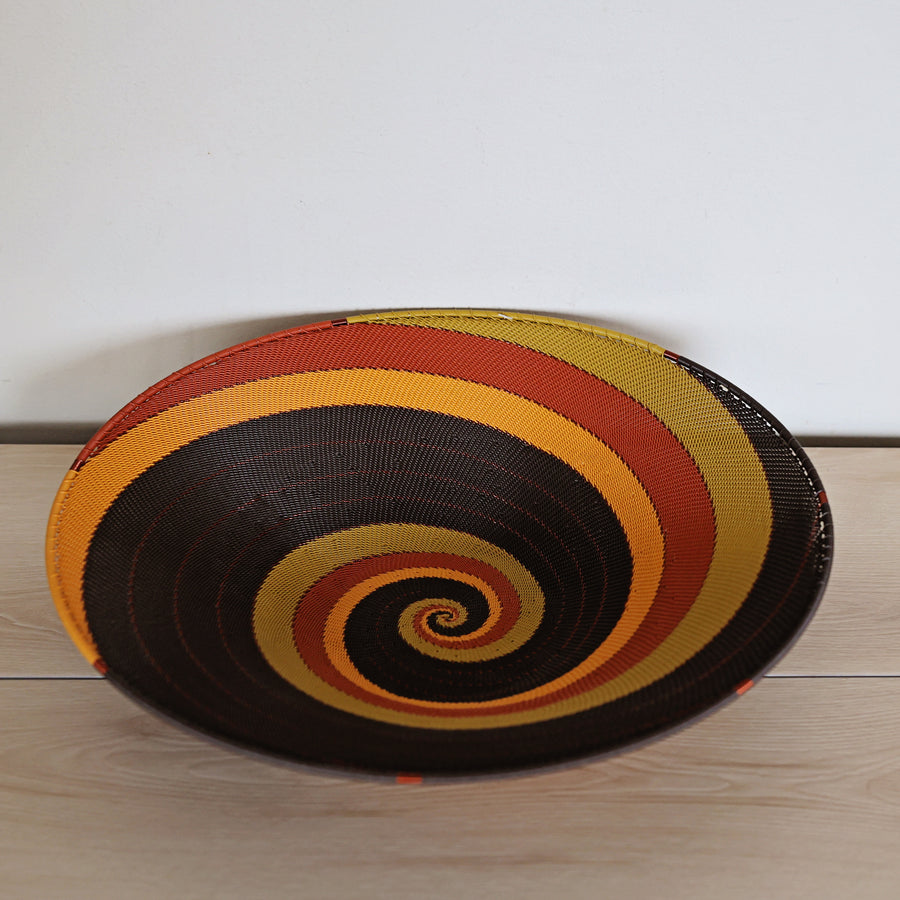 Dark Earth Zulu Large Shallow Basket handwoven in South Africa with rich brown, rust, golden yellow, and olive tones.