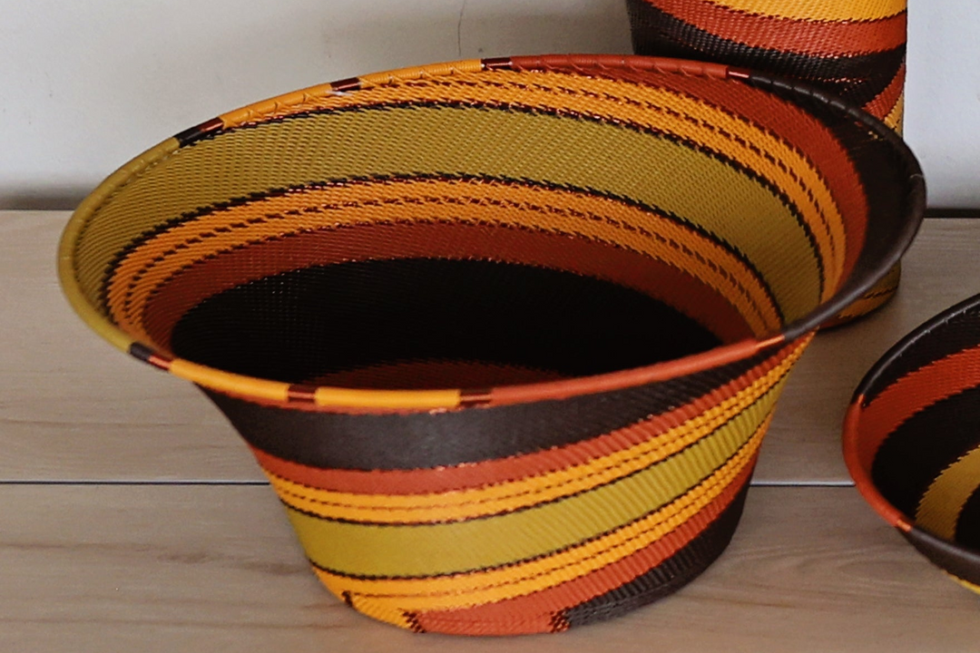 Dark Earth Zulu Large Flared Bowl handwoven in South Africa with rich brown, rust, golden yellow, and olive tones.