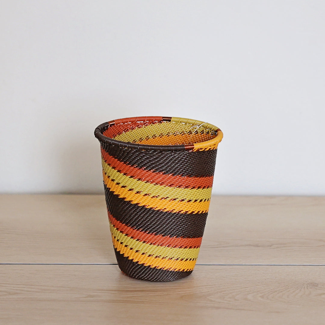 Dark Earth Zulu Wide Base Cup handwoven in South Africa with rich brown, rust, golden yellow, and olive tones.