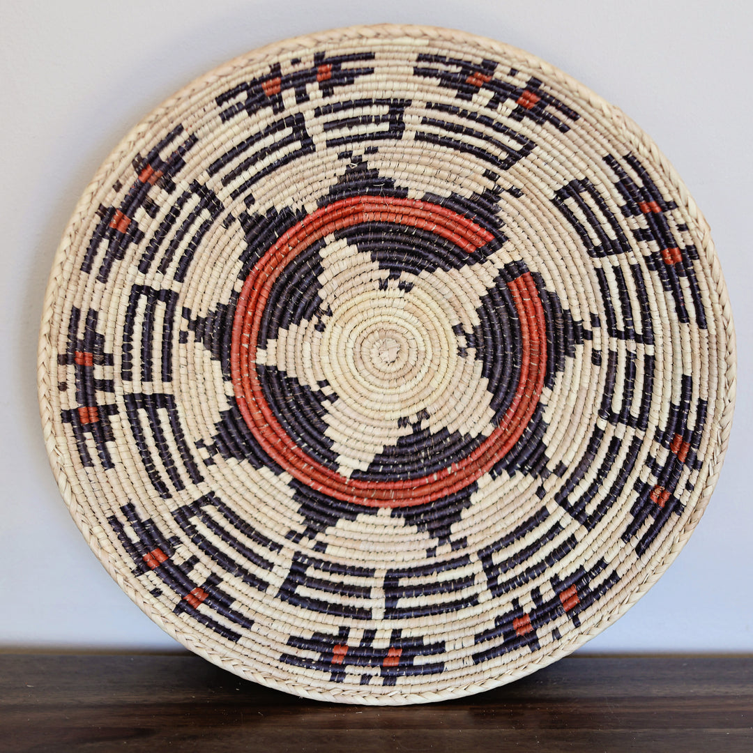 Decorative grass woven bowl used as wall art or hanging basket