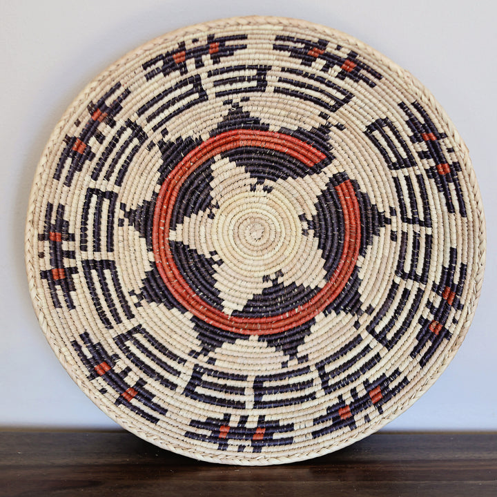 Decorative grass woven bowl used as wall art or hanging basket