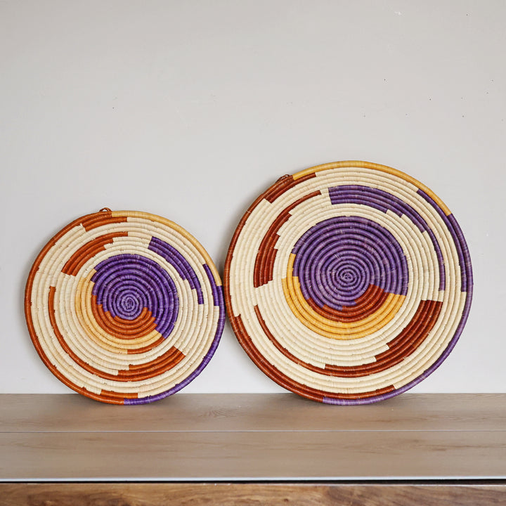 Handwoven Desert Spiral Bukedo and Raffia bowl handmade in Uganda featuring warm earth tones and a flowing spiral design.