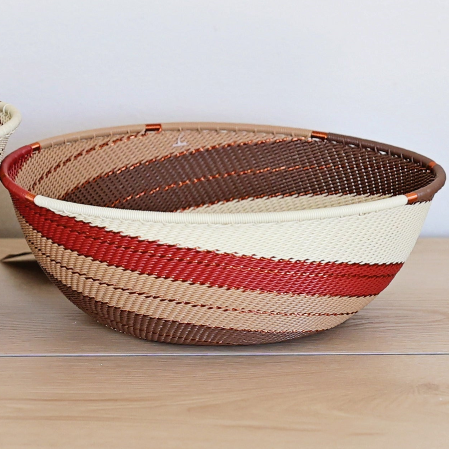 Desert Zulu Bowl handwoven in South Africa with ivory, rust, brown, and warm neutral tones in an intricate spiral pattern.
