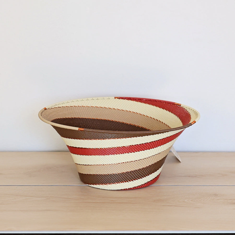 Desert Zulu Large Flared Bowl handwoven in South Africa with ivory, rust, brown, and warm neutral tones in a flowing spiral pattern.