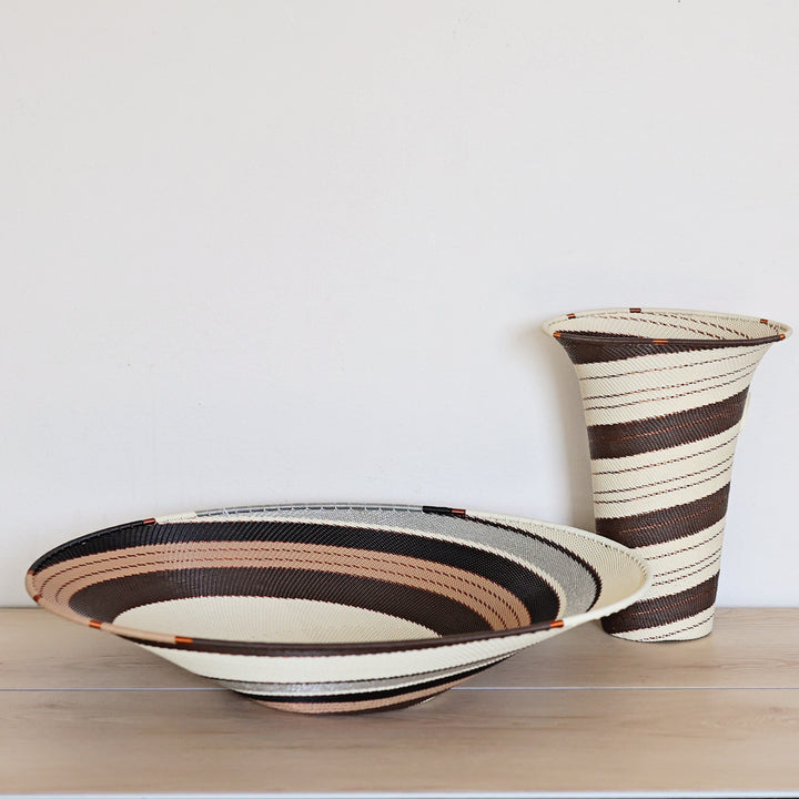 Side view of an Earth Tone Zulu Extra Large Shallow Basket and vase featuring intricate handwoven wire craftsmanship by South African artisans.