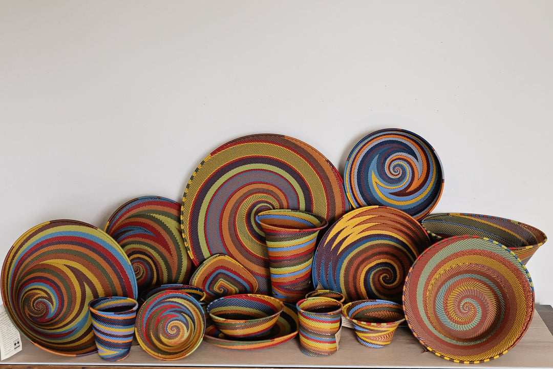 Handwoven Earthy Rainbow Zulu wire basket from South Africa in warm rust, ochre, olive, blue and brown.