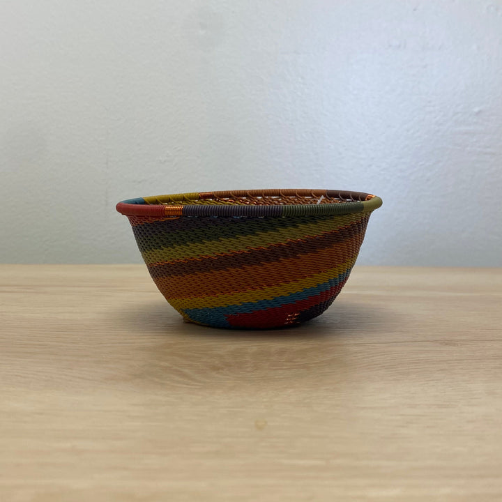 South African Zulu wire small bowl handwoven in a warm Earthy Rainbow spiral pattern.