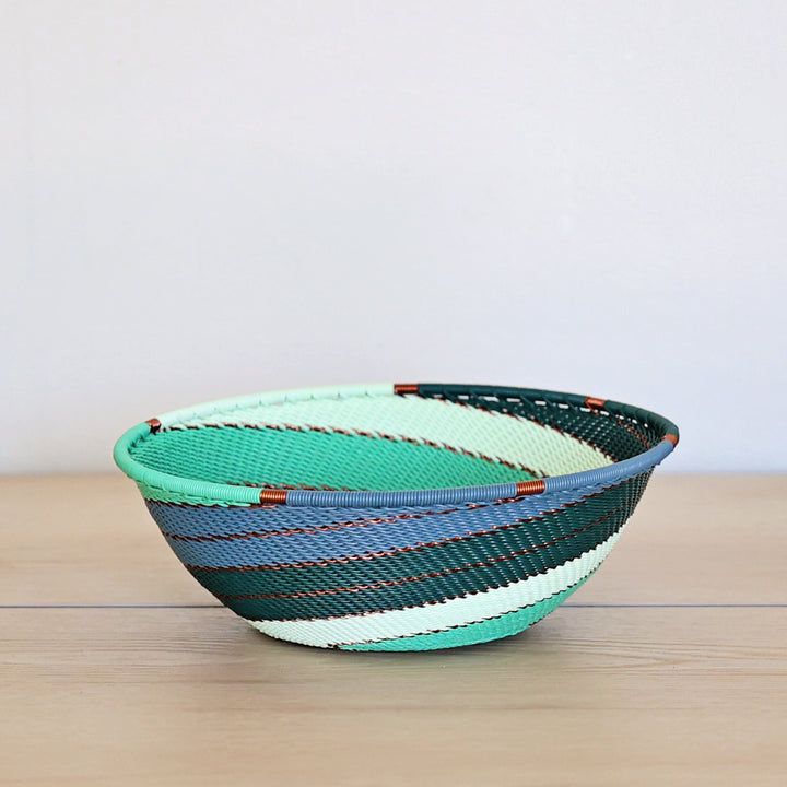 Emerald Zulu Small Flared Bowl handwoven in South Africa with emerald and soft mint diagonal stripes.