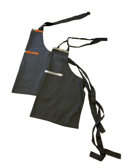 Handmade black African print apron from Kenya crafted from 100% cotton for cooking and entertaining.