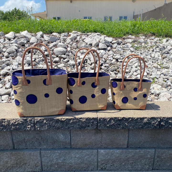 Fair trade Madagascar Dotted Raffia Market Tote featuring natural woven texture and bold abstract circles.