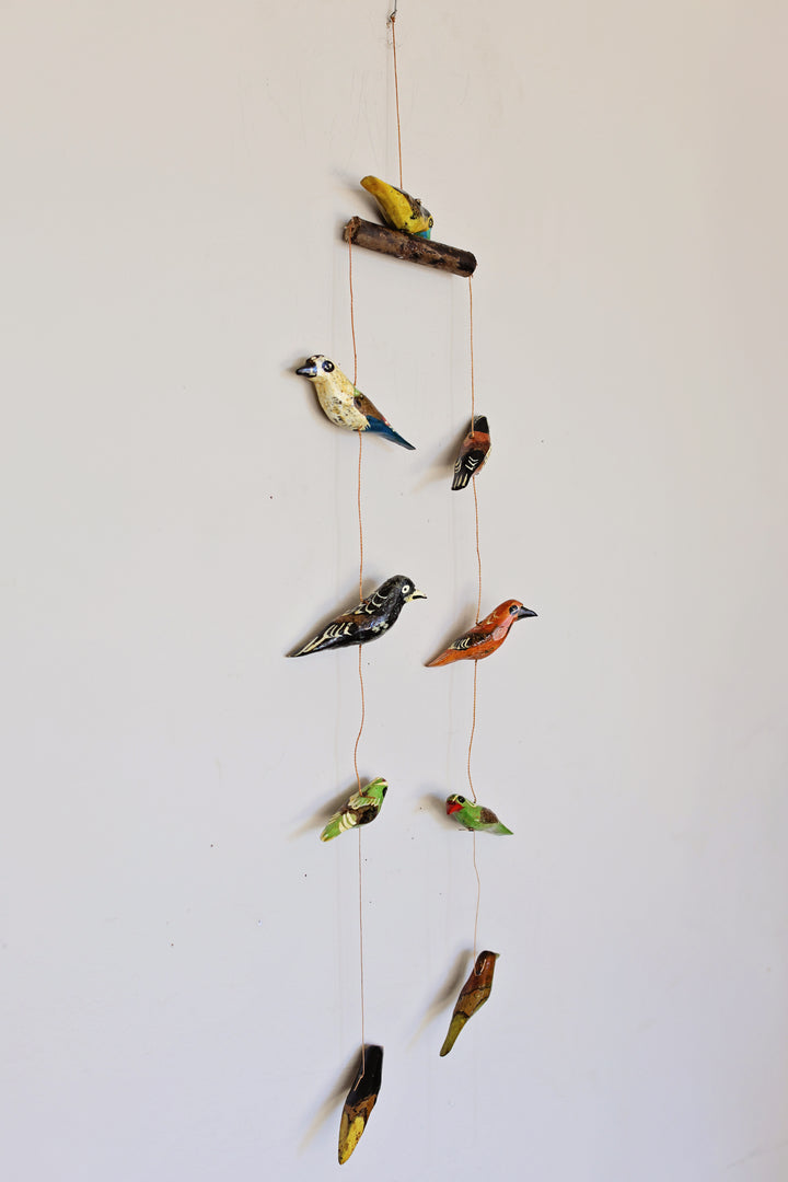 Fair trade nursery bird mobile with nine carved wooden birds and vibrant detail