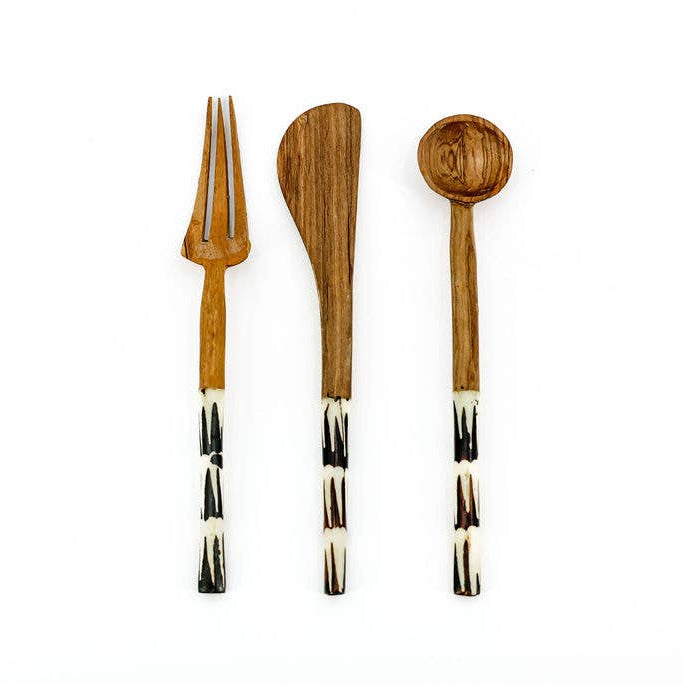 Detail view of carved bone handle on fair trade wood cutlery utensil.