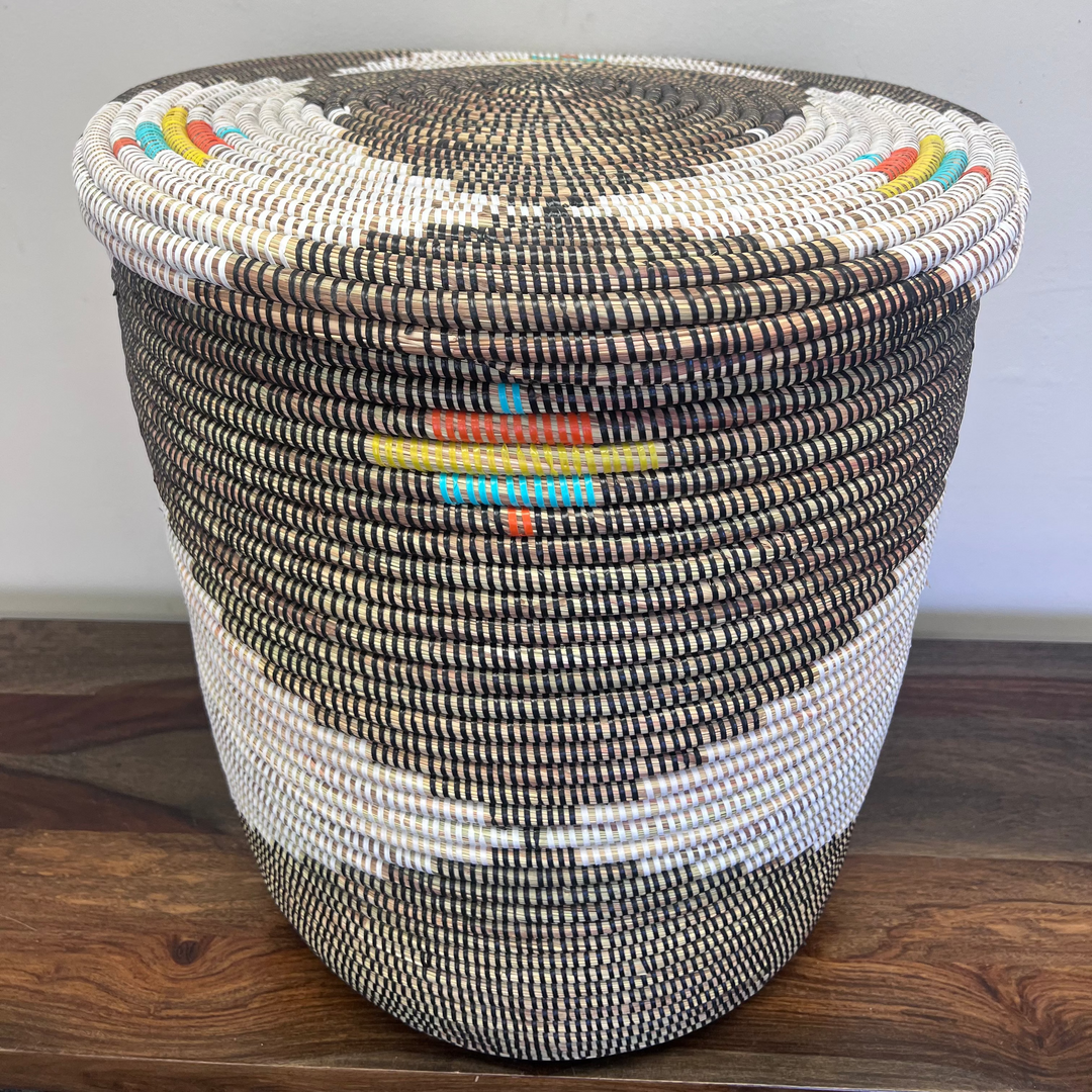 Flat-lidded sweet grass laundry hamper in earth tone pattern, front view.