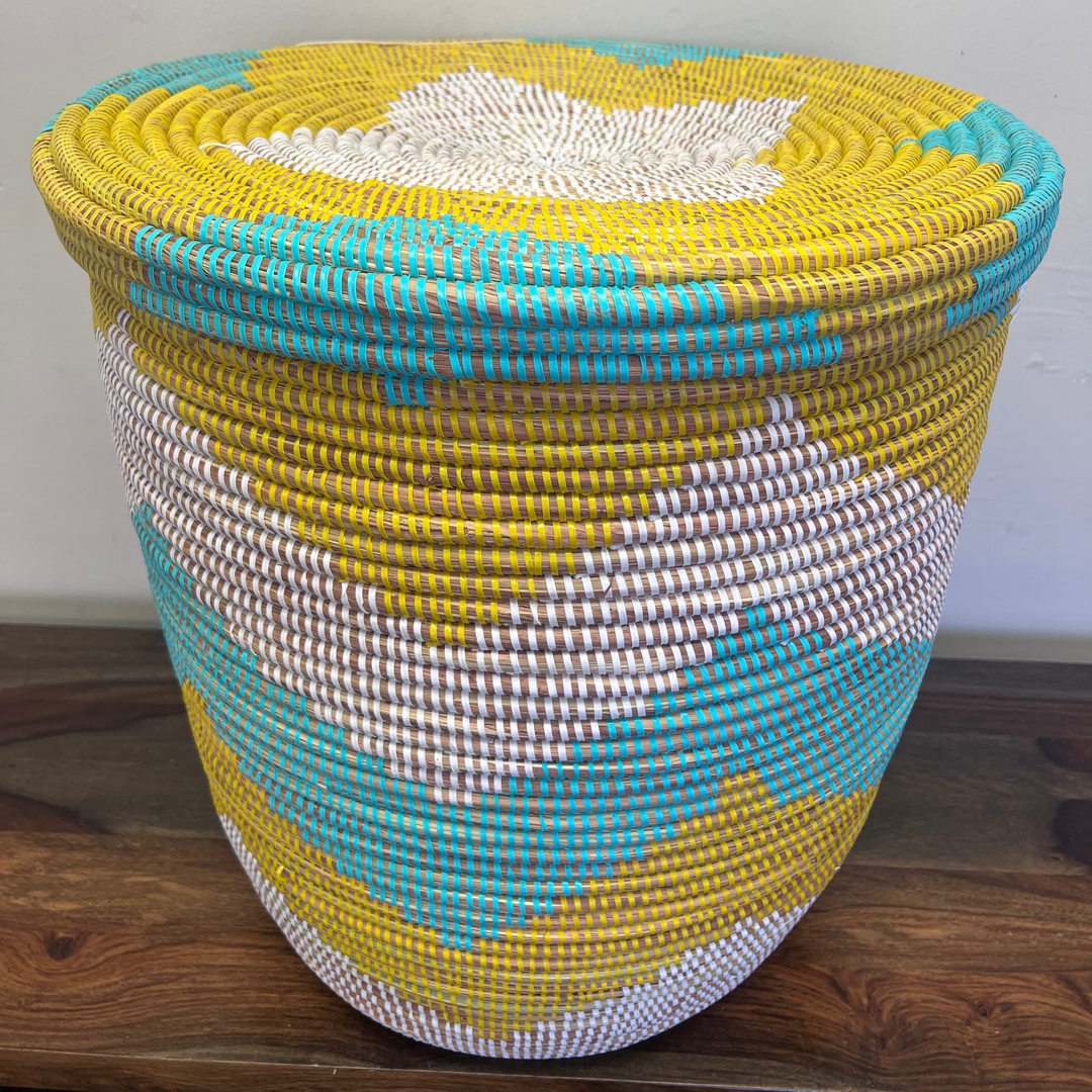 Fair trade flat-lid laundry hamper with lid secured on top, handwoven in Africa.