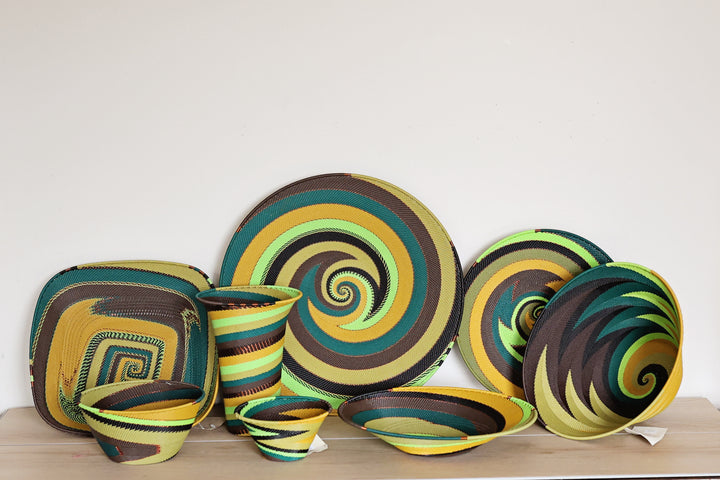 Assorted Forest Zulu Wire Baskets handwoven in South Africa in green, golden yellow, brown, and black woven patterns.