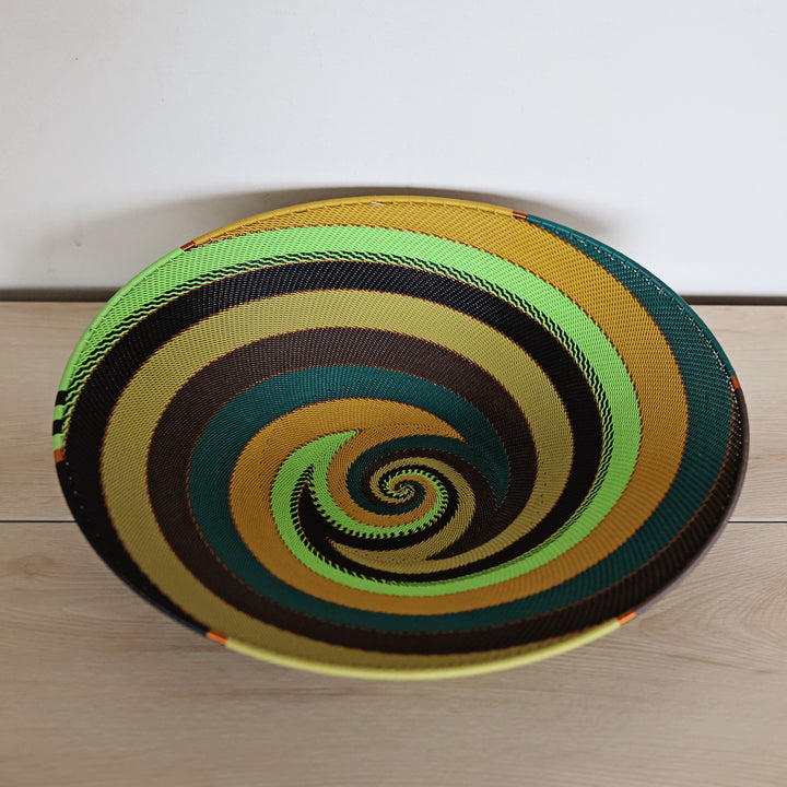 South African Forest Zulu Wire Extra Large Shallow Basket in teal green, olive, brown, and yellow.