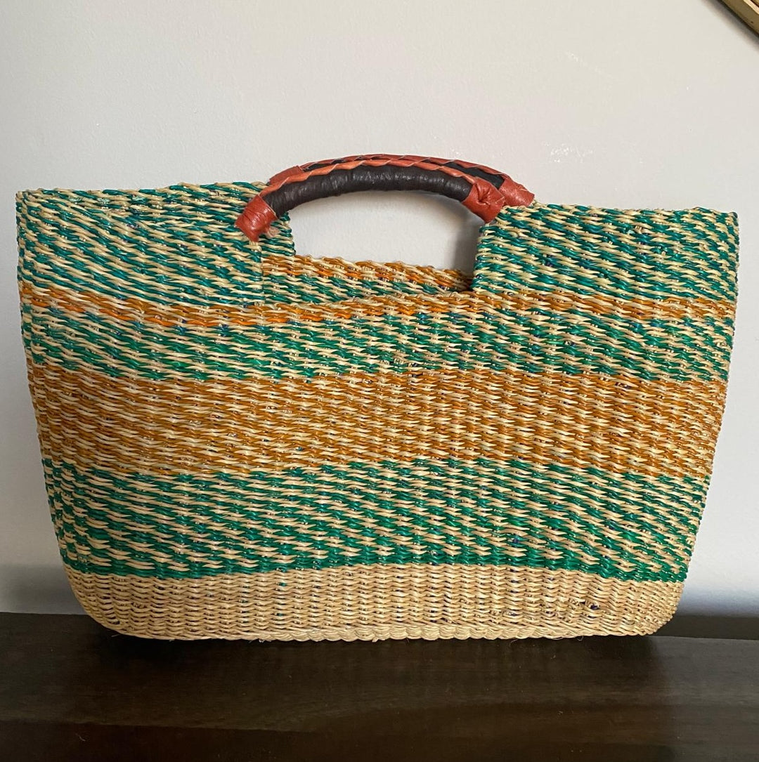 Woven bag with green and brown stripes on a white background