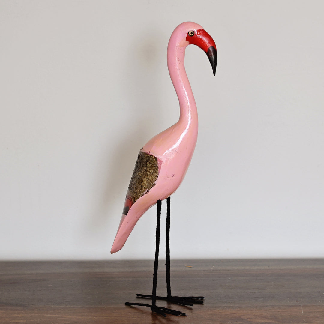 Close-up of a handcrafted Wooden Pink Flamingo featuring hand-painted details and adjustable yarn-wrapped wire legs, made in Kenya.