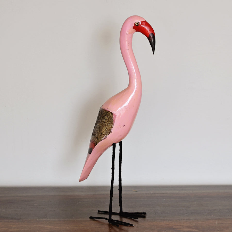 Close-up of a handcrafted Wooden Pink Flamingo featuring hand-painted details and adjustable yarn-wrapped wire legs, made in Kenya.