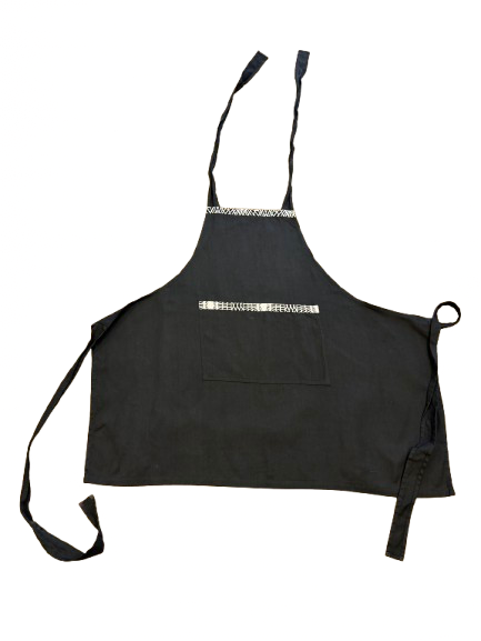Detail view of a handmade black 100% cotton apron featuring colorful African textile accents.