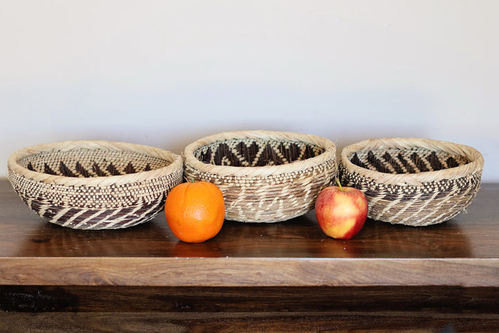 Shallow handwoven Tonga basket bowl used as African home decor centerpiece.