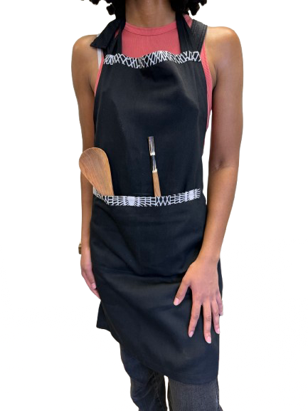 Handmade Kenyan apron crafted from 100% cotton with a classic black base and bold African print details.