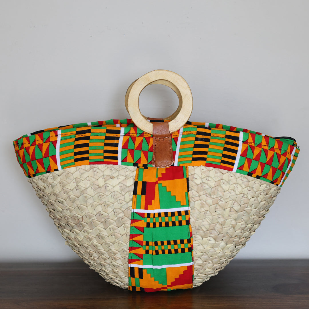 Large Kikapu Janet Tote handmade in Kenya with colorful assorted African fabric and wooden handles.