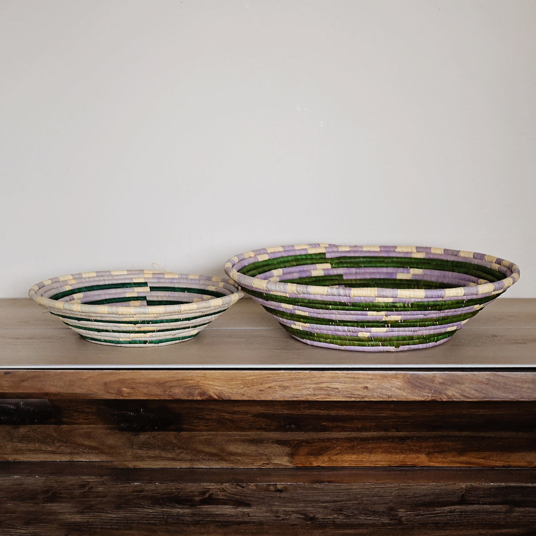 Side view of a Lavender Meadow Bukedo and Raffia bowl handcrafted in Uganda from banana leaf stalks and palm raffia in lavender, sage green, and natural tones.
