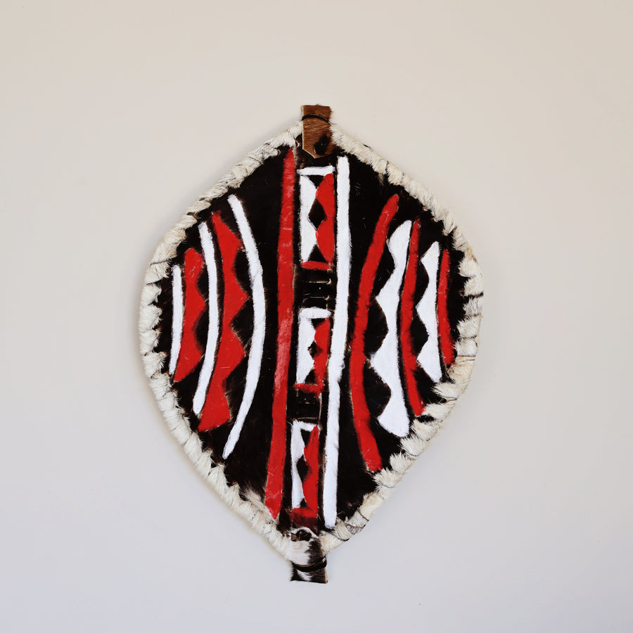 Handcrafted leather Kenyan shield with traditional patterns used as cultural wall decor
