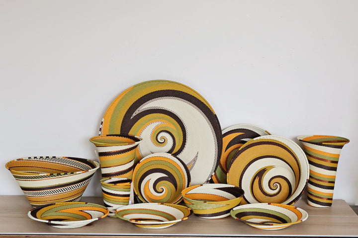Assorted Light Earth Zulu Wire Baskets handwoven in South Africa in warm ivory, ochre, sage, brown, and rust tones.