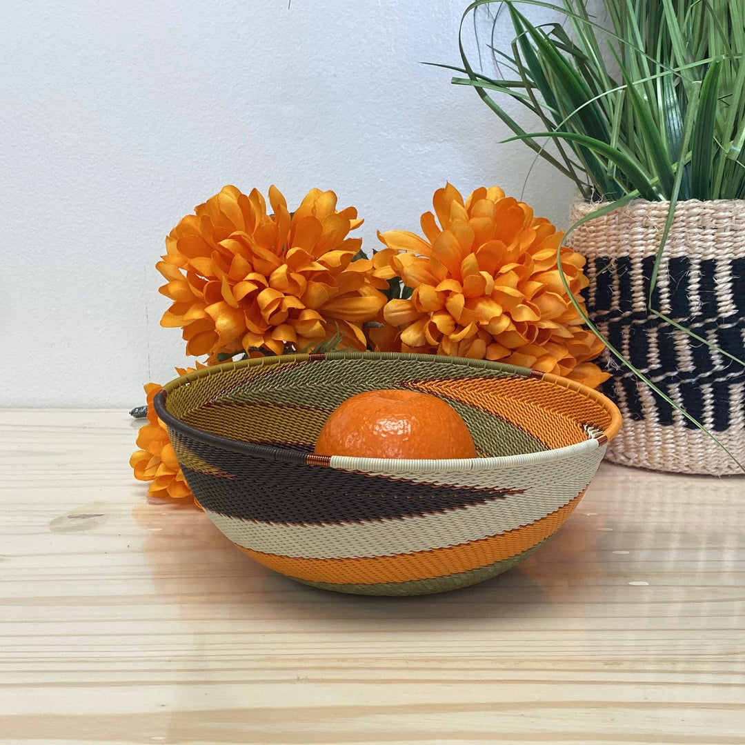 Light Earth Zulu Wire Bowl handwoven in South Africa in warm ivory, ochre, sage, and earthy brown tones.