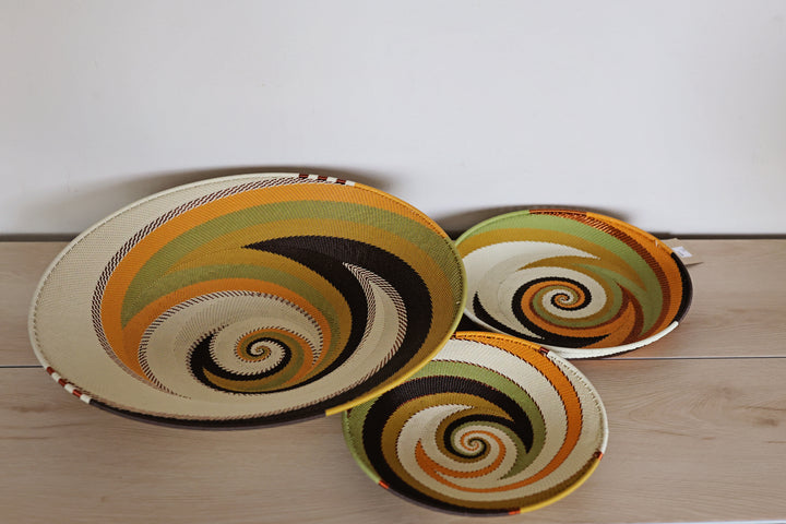 Light Earth Zulu Wire Small Shallow Basket handwoven in South Africa in warm ivory, ochre, sage, and earthy brown tones.