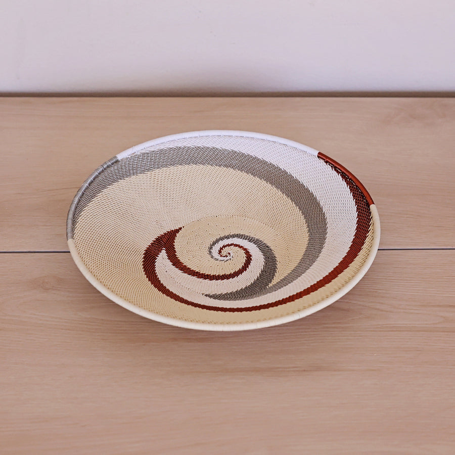 Mist Zulu Large Shallow Basket handwoven in South Africa with soft mist gray and white tones in a diagonal stripe pattern.