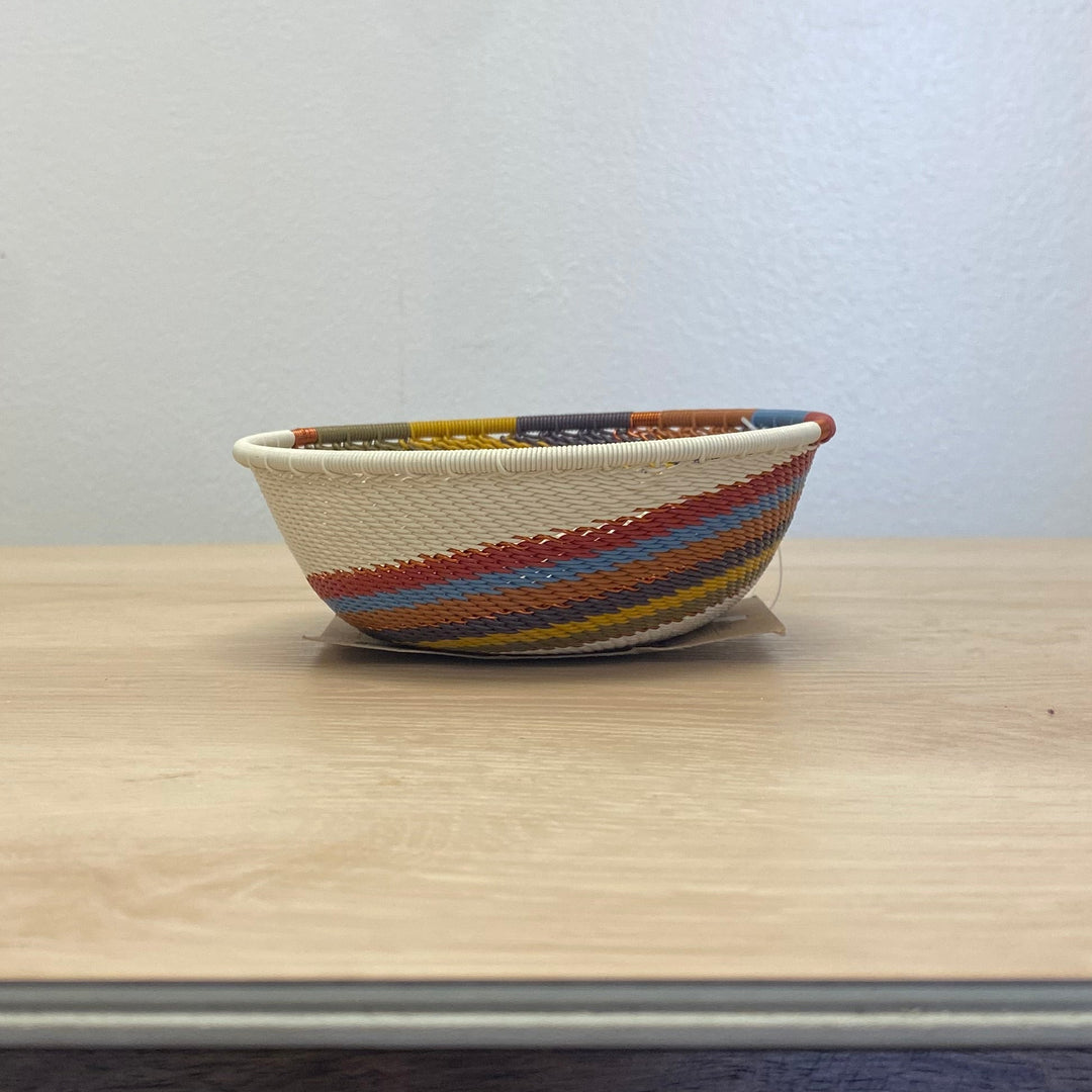 Artisan-made Mountain Rainbow Zulu small wide bowl handwoven in South Africa with warm earth-tone stripes.