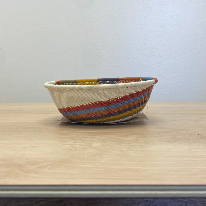 Artisan-made Mountain Rainbow Zulu small wide bowl handwoven in South Africa with warm earth-tone stripes.