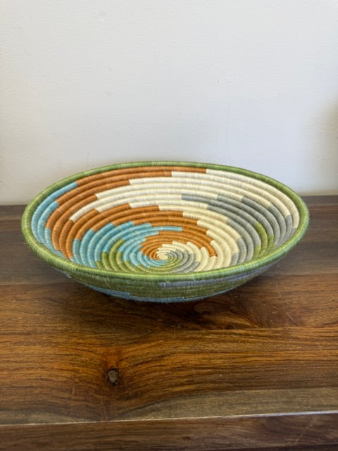 Side view of the Multicolor Spiral Rwanda sisal basket handcrafted by fair trade artisans using sustainable sisal fibers.