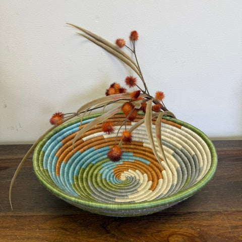 Handwoven Multicolor Spiral Rwanda sisal basket with vibrant concentric woven patterns viewed from above for fair trade wall décor.