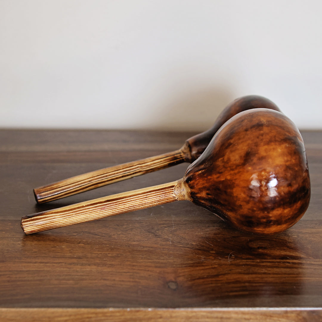 Kenyan hand-carved gourd percussion instrument made by skilled artisans.