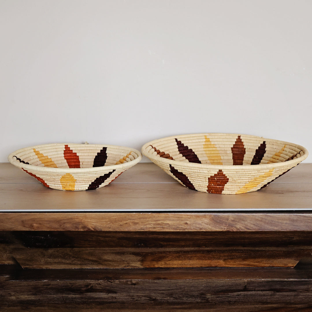 Side view of a Natural Leaf Bukedo and Raffia bowl handcrafted in Uganda from banana leaf stalks and palm raffia with a woven leaf motif.