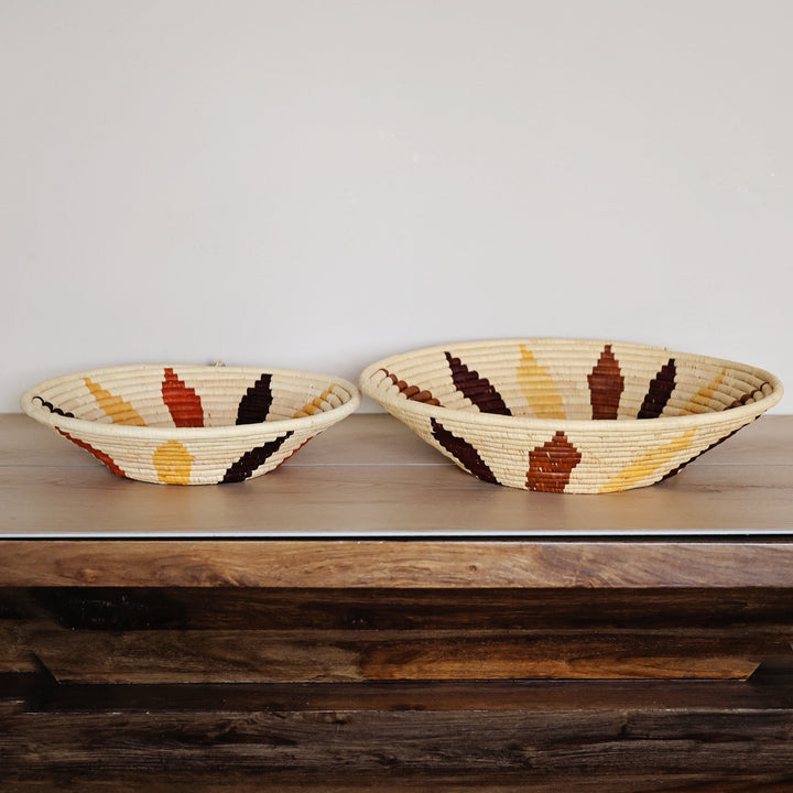 Side view of a Natural Leaf Bukedo and Raffia bowl handcrafted in Uganda from banana leaf stalks and palm raffia with a woven leaf motif.