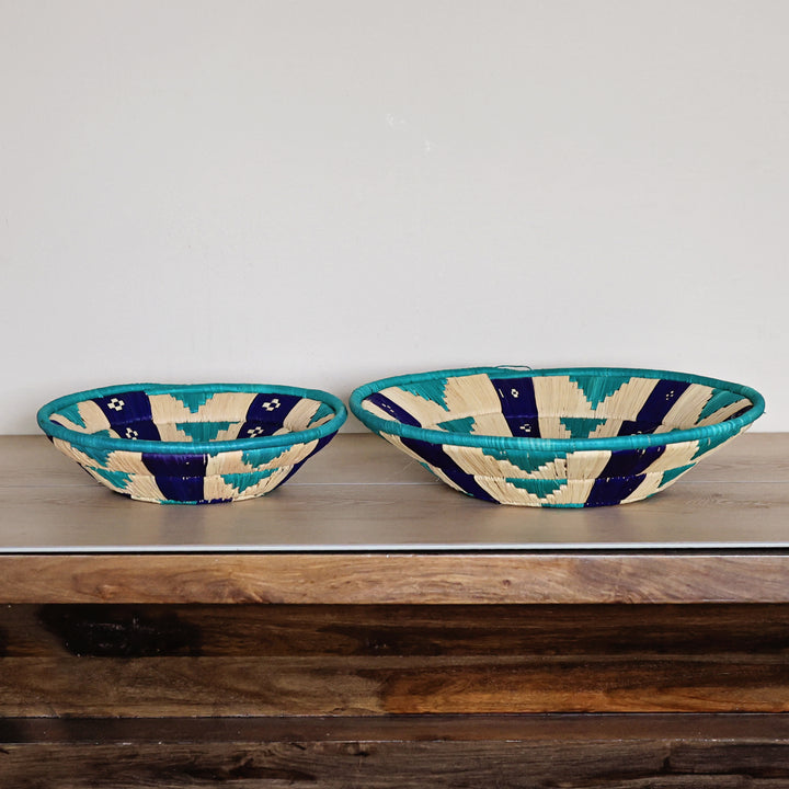 Side view of a Natural & Teal Bukedo and Raffia bowl handcrafted in Uganda from banana leaf stalks and palm raffia.